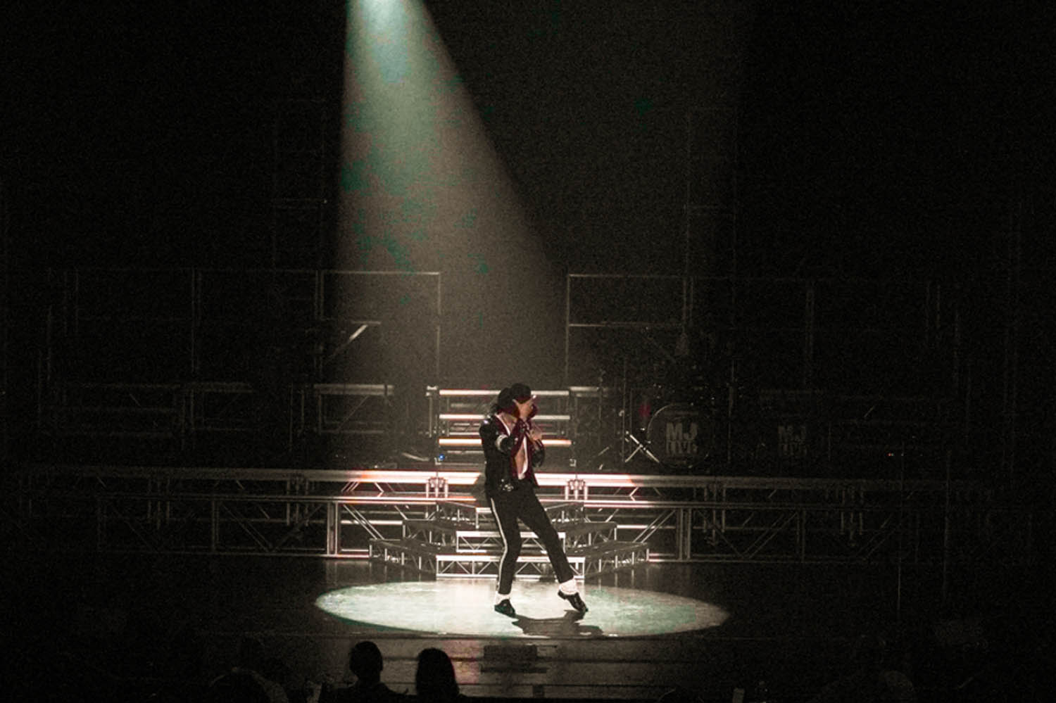 An MJ Live performer in the spotlight on stage